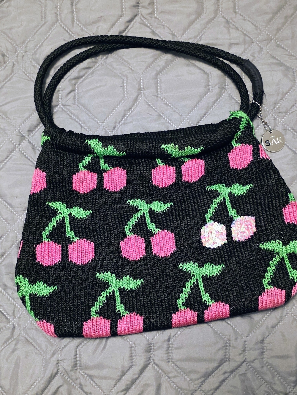 The Sak Black Knit Shoulder Bag with Pink Cherry Motif